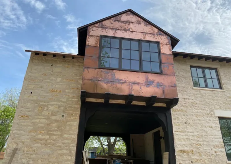 Copper metal panel facade on a stone building for Metal Roof Coating in Natchez